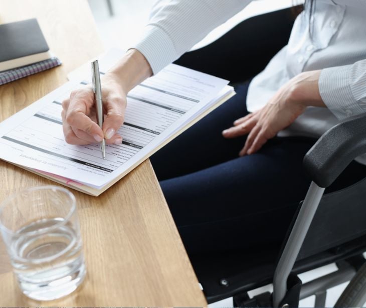 person at desk filling out forms