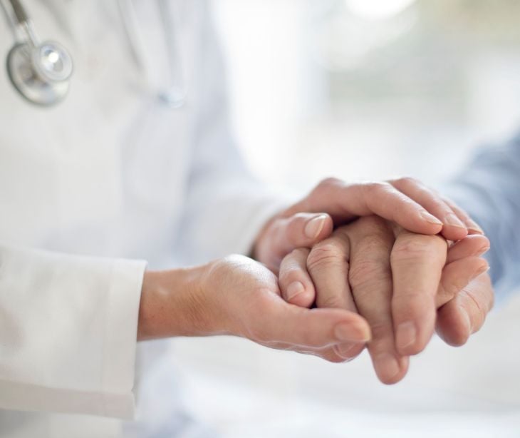 provider holding patient hand