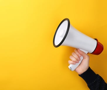 Image of megaphone with yellow background. 