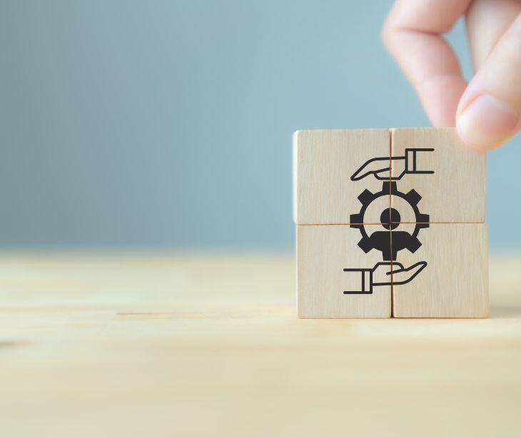 hands and wheel symbol on wooden blocks