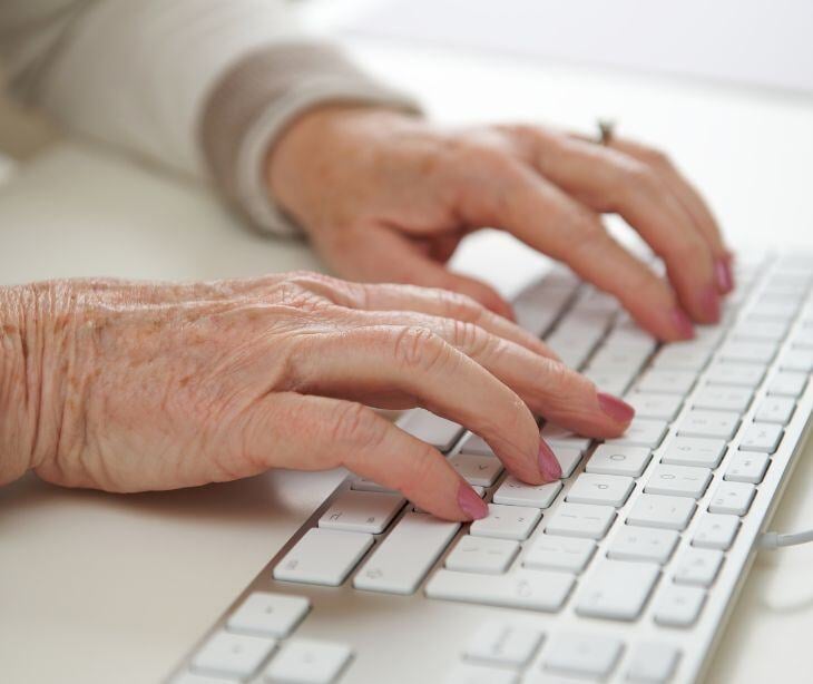 elderly hands at computer