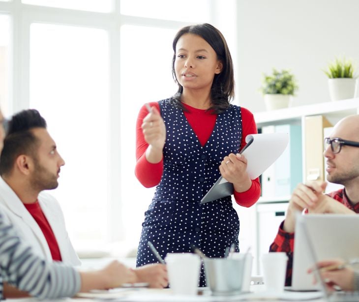 employee leading a meeting in a conference room