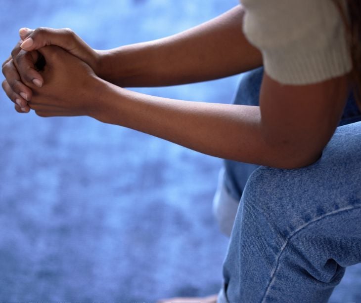 person sitting with folded hands