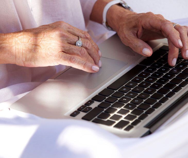 older hands at a computer