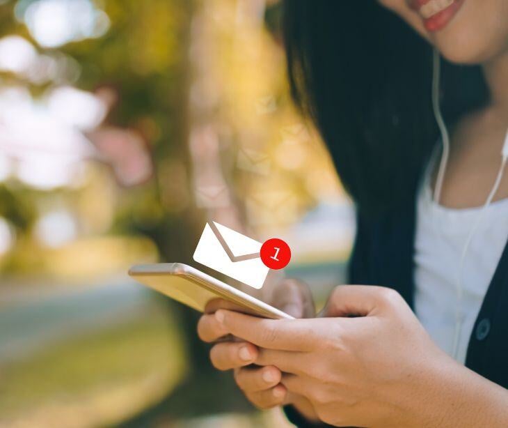 woman on phone with email icon for post Enhancing patient engagement in psychiatric care with HIPAA compliant email