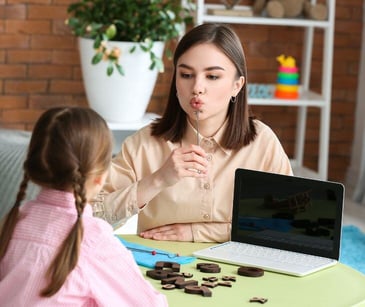 speech pathologist with child patient