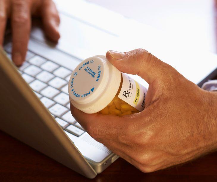 laptop and prescription bottle