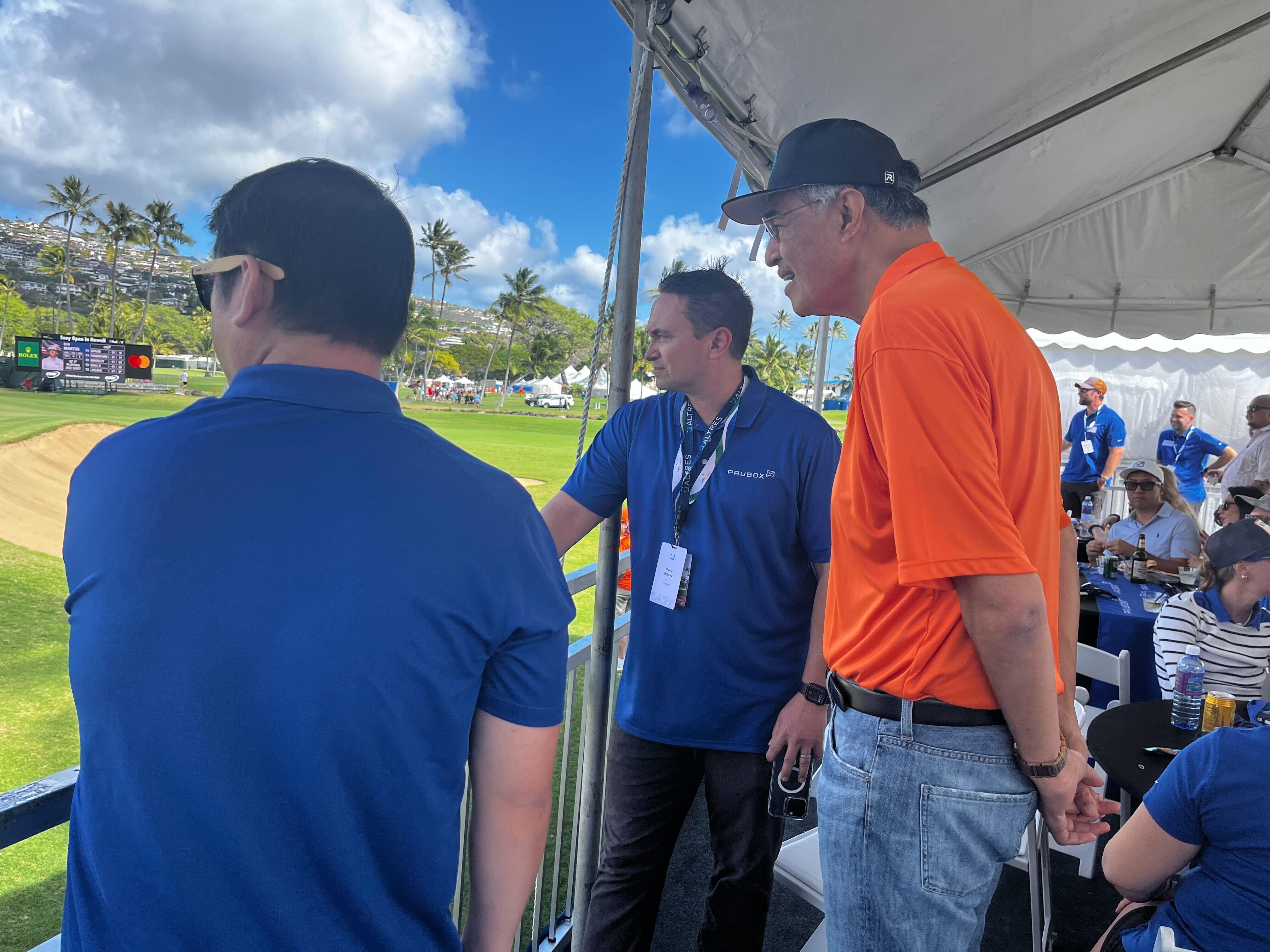 Chatting while watching the golf.