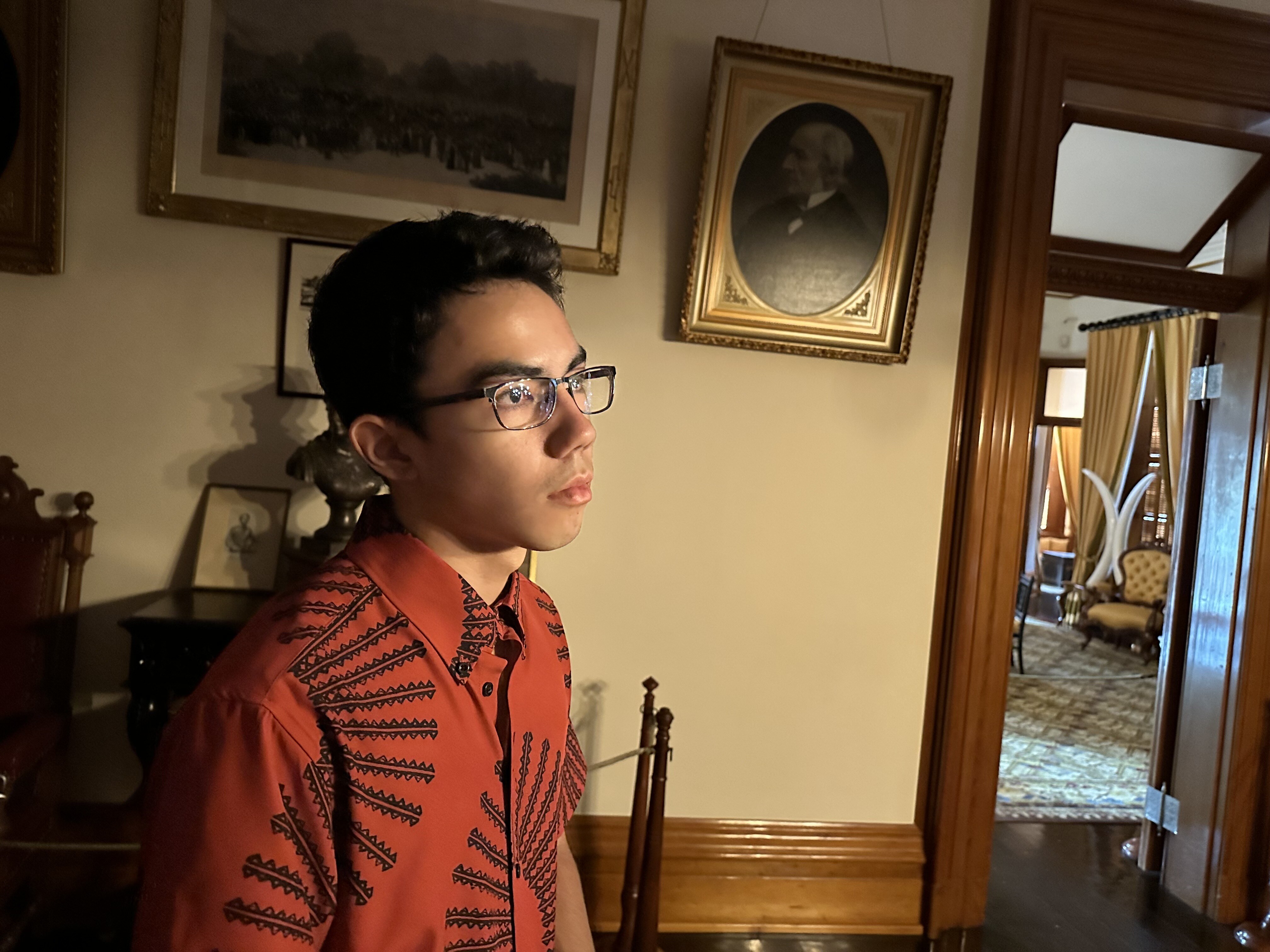 Colton Mills, deep in thought, in Kalākaua's Bedroom | A tour of ʻIolani Palace - Paubox Kahikina Scholarship