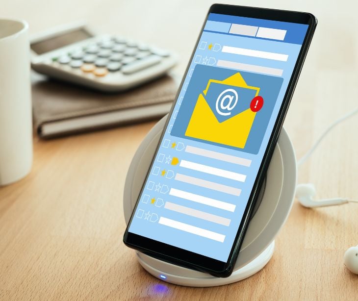 smartphone on desk with email notification on screen