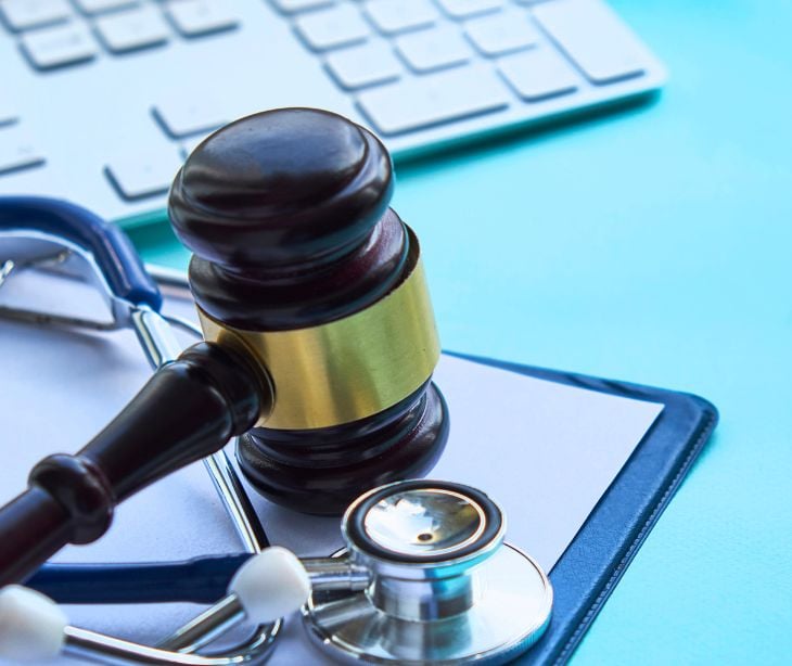 law gavel with stethoscope and keyboard