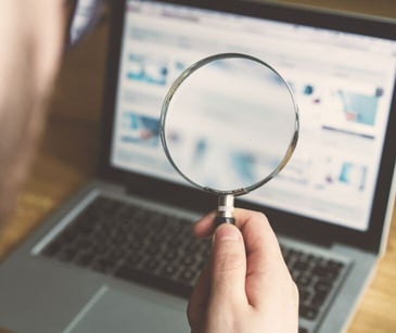 magnifying glass in front of computer