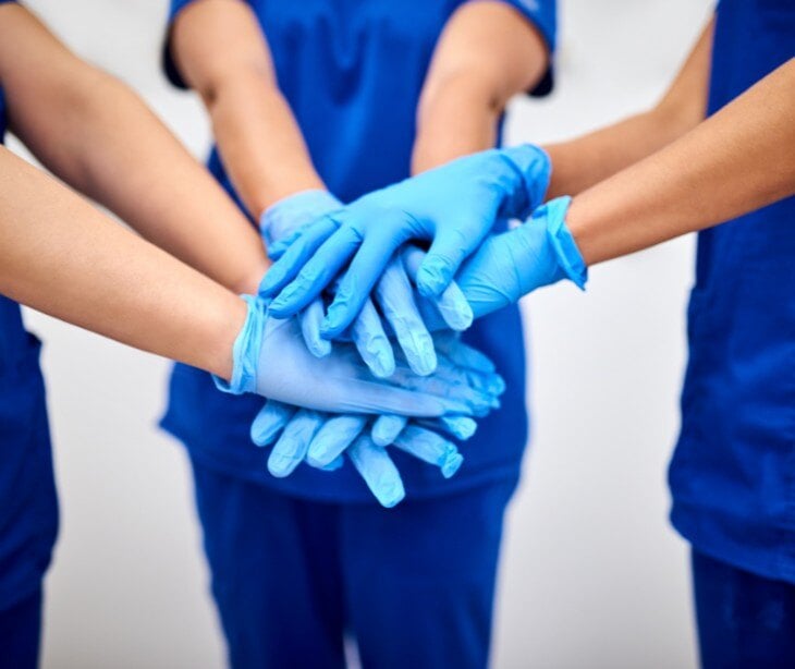 Image of hands in gloves. 