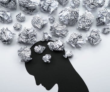 head silhouette with crumpled paper for post Overcoming mental health stigma