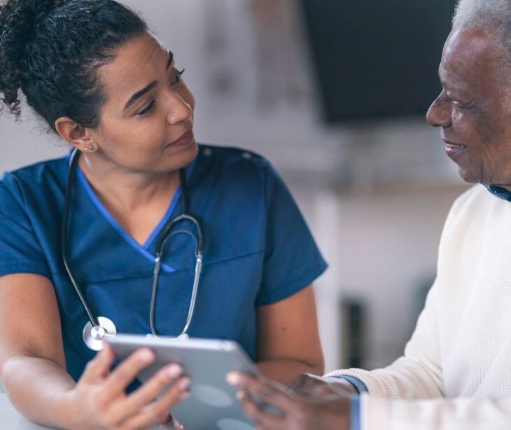 nurse with man and tablet