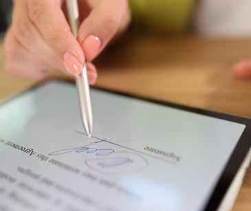 Image of someone signing an electronic document for blog about Setting up HIPAA compliant e-signatures for patient forms