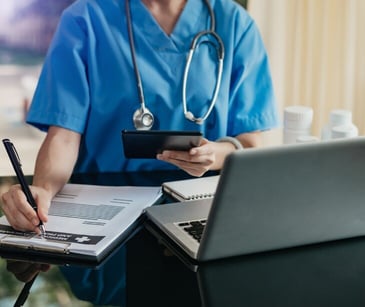 Image of nurse taking notes for blog about How email can educate staff on workplace confrontations