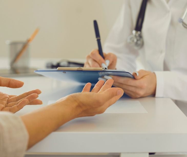 provider with paperwork interacting with patient