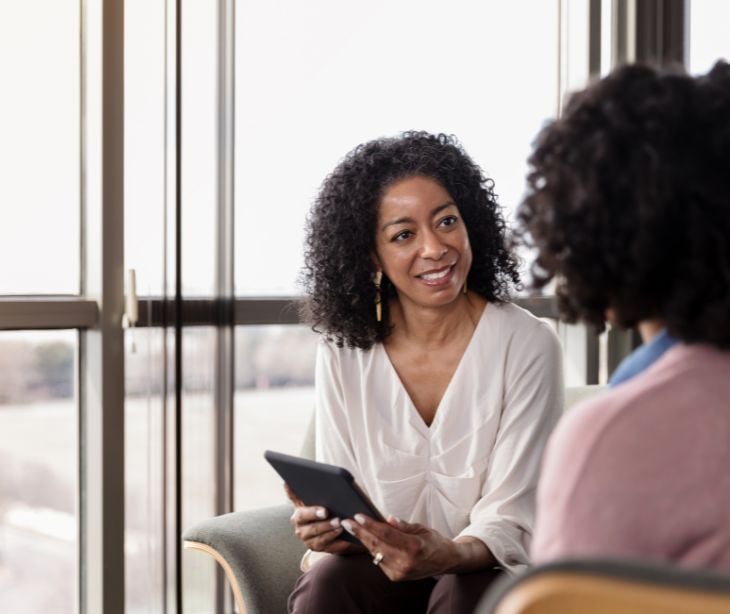 therapist with patient holding tablet