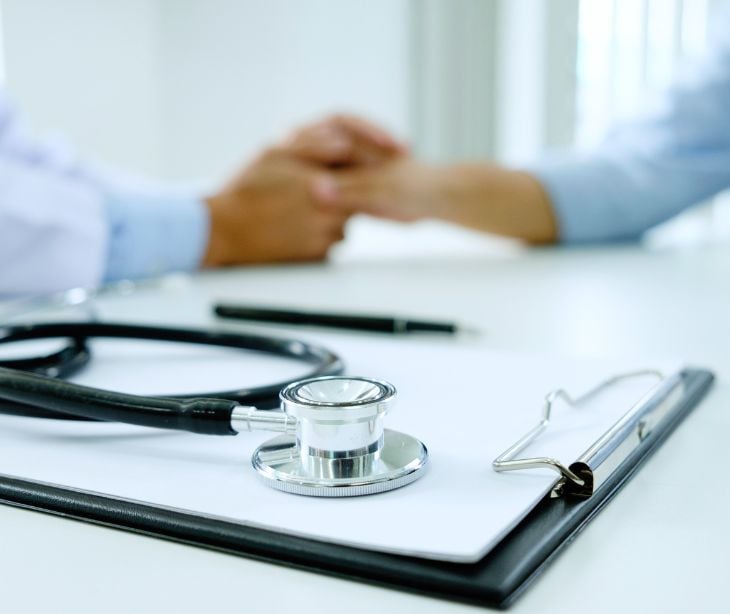 patient and provider hands with stethoscope