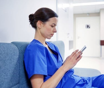 health professional on smartphone for post Staff training to prevent accidental PHI disclosure via text messaging