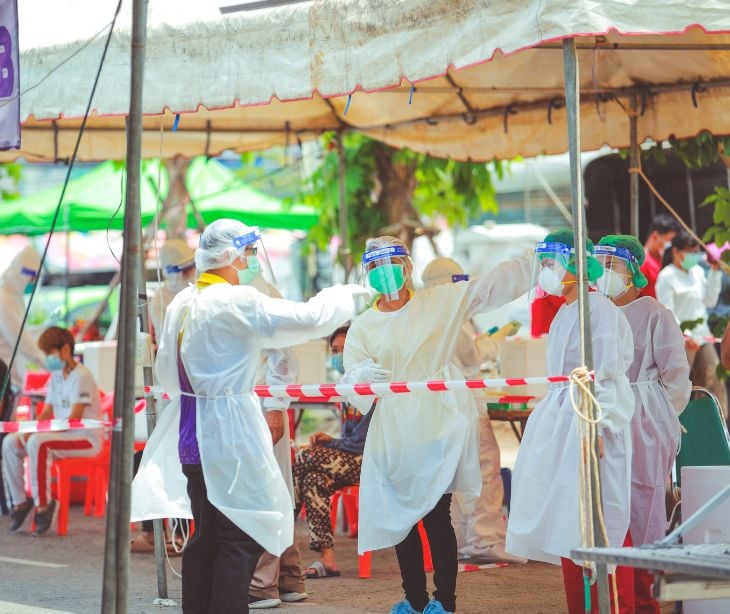 providers in safety gear in a tent public health