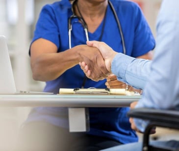 healthcare worker shaking patient hand