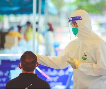 public health worker administering vaccine in outdoor tent