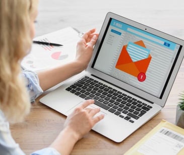 woman checking email on laptop