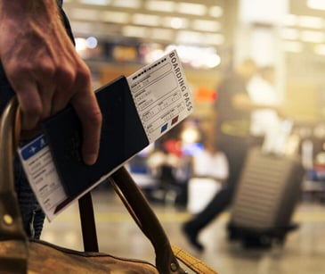 holding boarding pass in airport