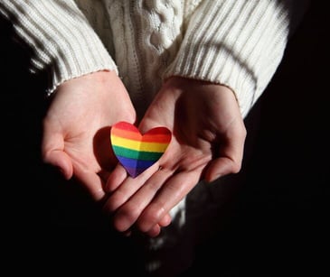 rainbow heart in hands