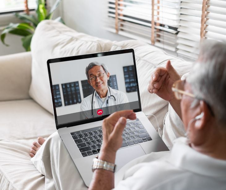 man on laptop using telehealth