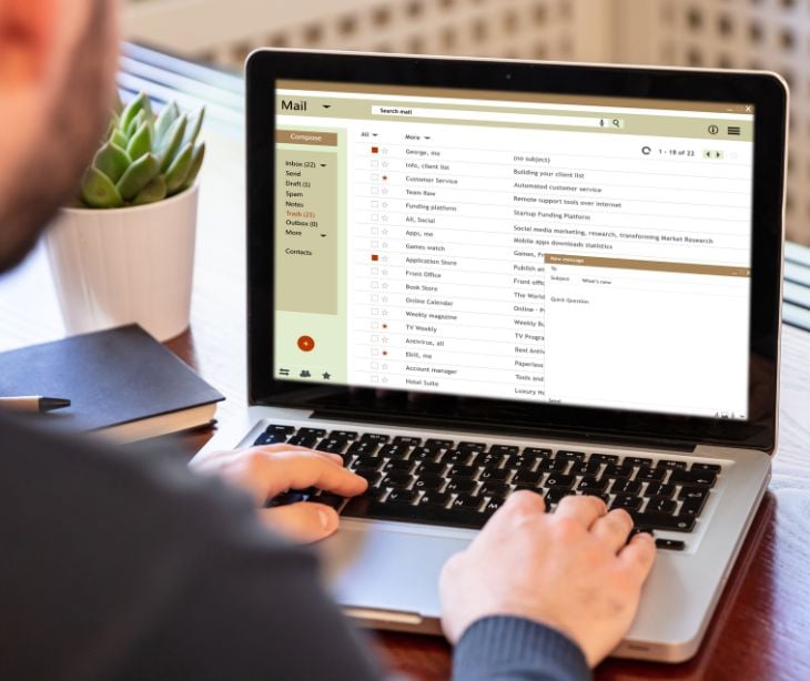 person on laptop sending email 