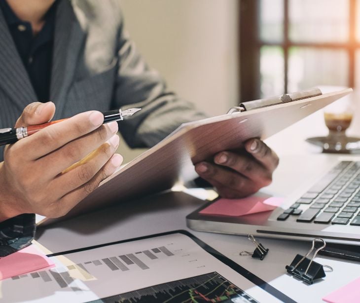 person at desk looking over paperwork