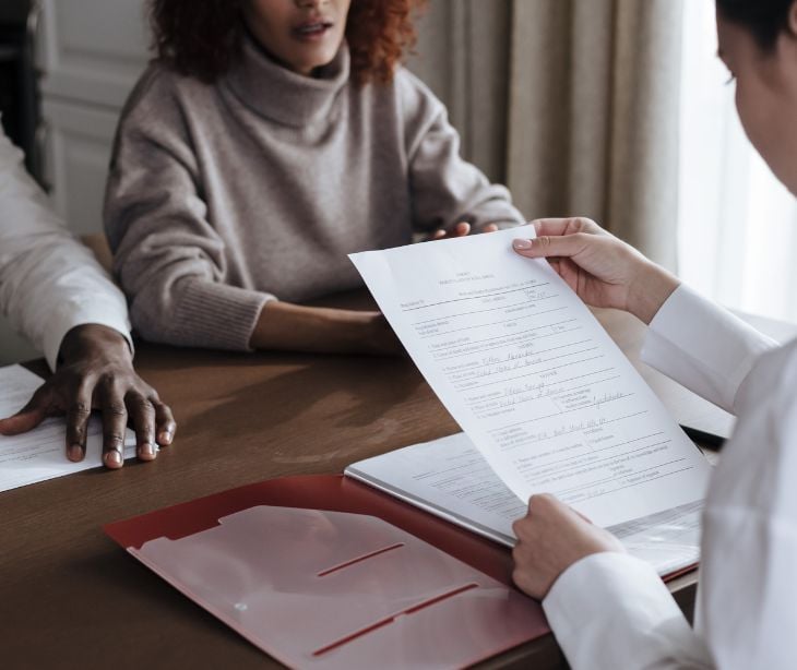 patients and providers going over paperwork