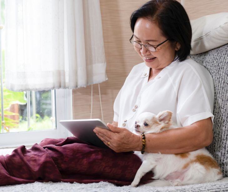 woman on tablet with dog